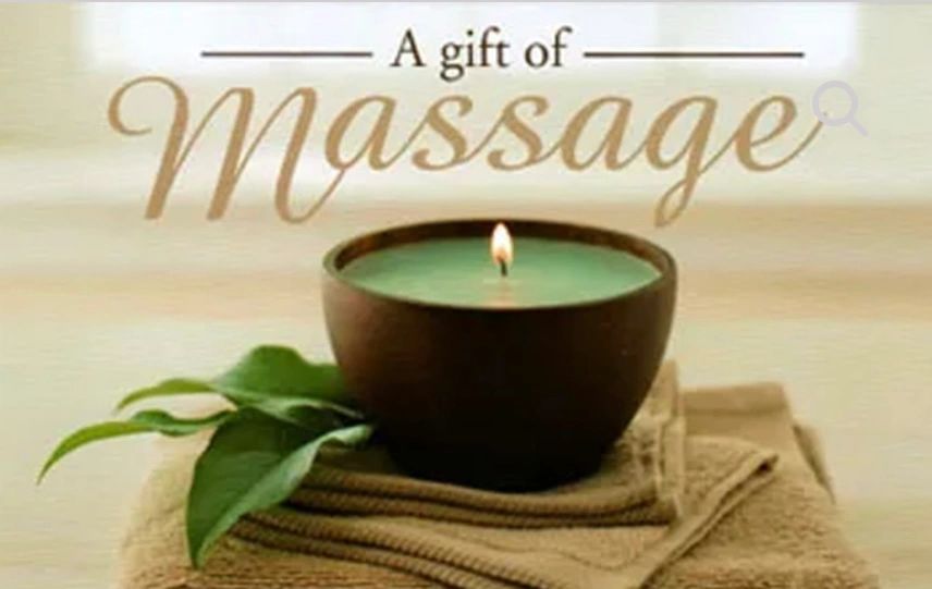 Candle on table represents massage gift cards 
