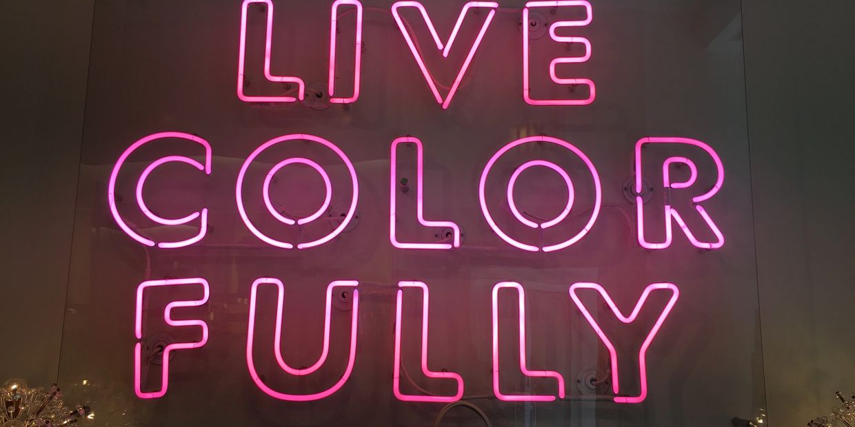 Neon signage for,"Live Colorfully", party bus