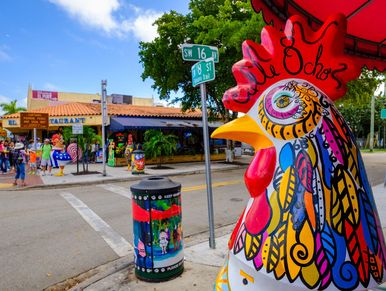 Colorful Havana Rooster statue standing in front of Domino Park during a ¡HolA! Miami City Tour.