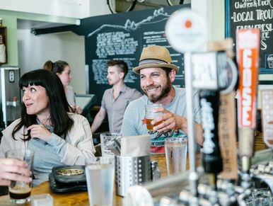 Crowd enjoying a brewery event with beer tastings during the North DC Brewery and Art Tour.