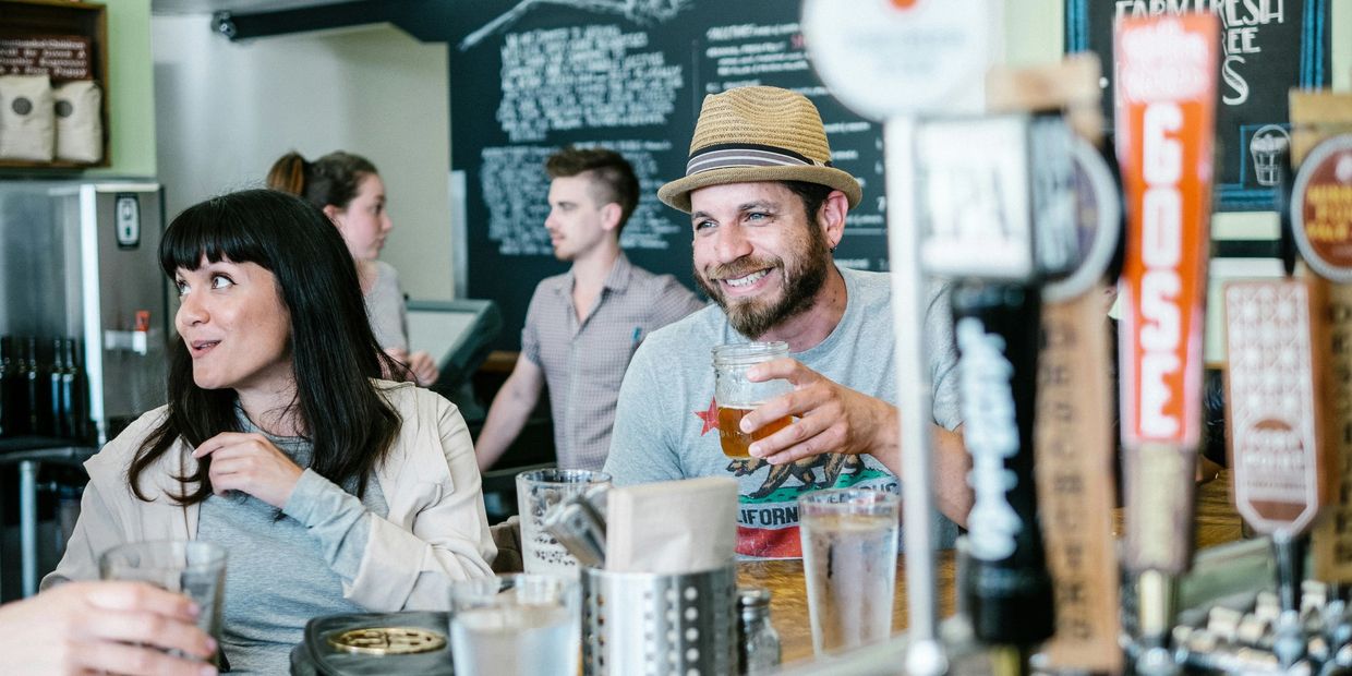 Crowd enjoying a brewery event with beer tastings during the North DC Brewery and Art Tour.