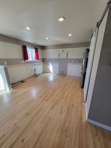 Finished kitchen after demolition. Clean empty room. Cabinets, countertops, and appliances removed.