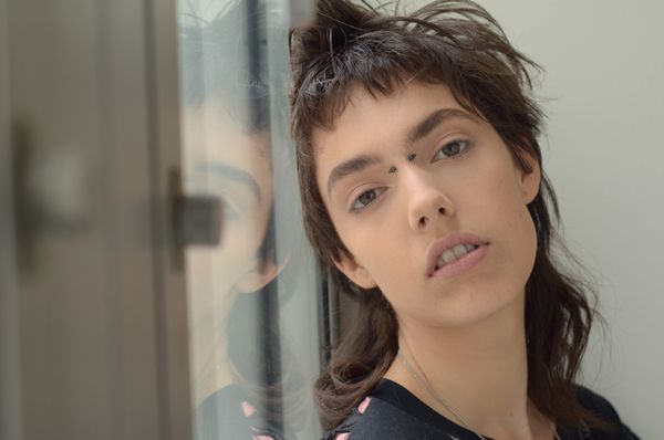 Close-up of model Kye Howell with short tousled brown hair and minimal makeup.