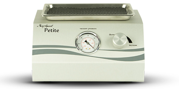 A NewApeel Petite machine, for aesthetic treatments, with a cream-colored body and gray accent.