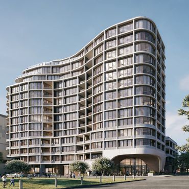 Modern curved glass building with balconies and people outside.