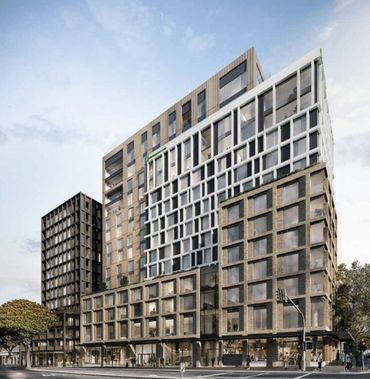 Modern multi-story building with varied architectural design and large windows.