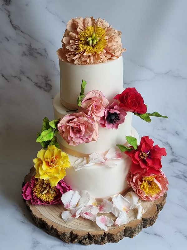 Hand crafted wedding cake with any arrangement of sugar & cold porcelain flowers.