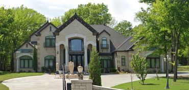 Custom home with rock veneer and extensive detailing.