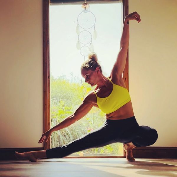 Lu Mays performing a yoga pose