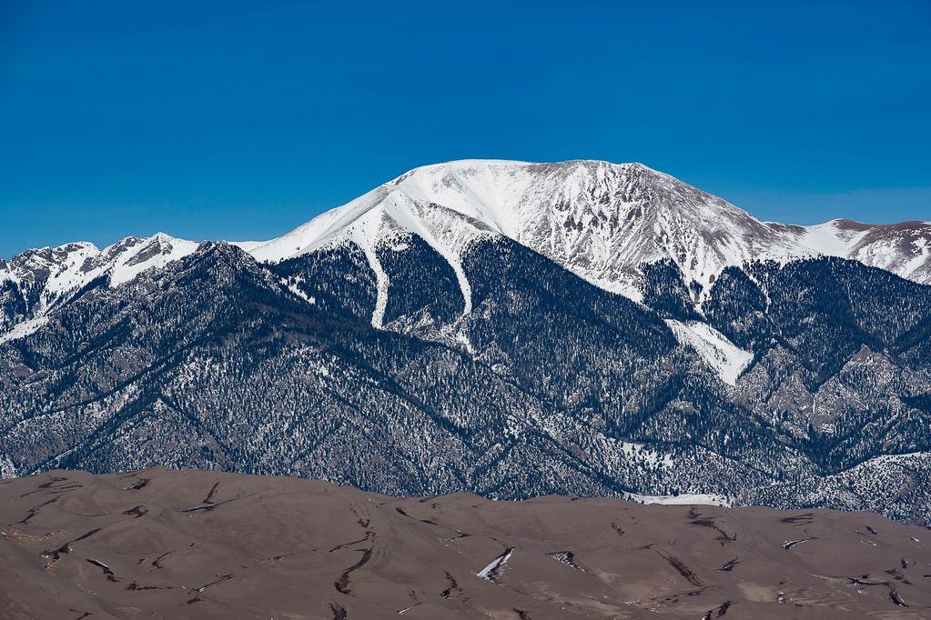 Sand Dune with Sangre de Cristo Range Mountains in background 