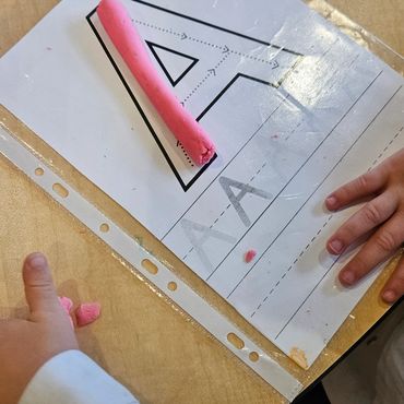 Preschoolers play with playdough to work their dexterity and fine motor skills.