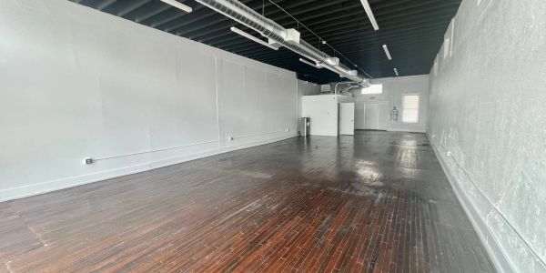 Empty room with wooden floor and white walls.