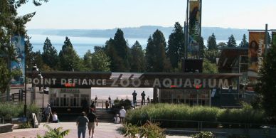 Entrance to Point Defiance Zoo and Aquarium with scenic backdrop.