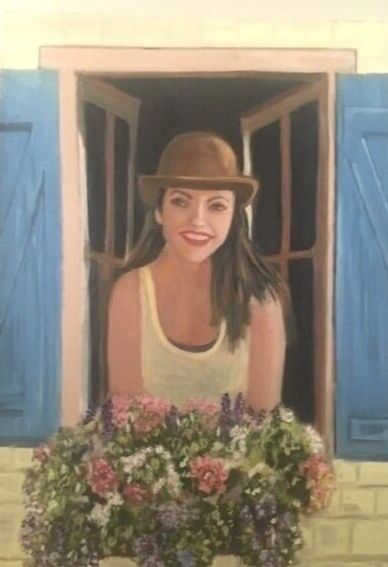 Woman in brown hat smiling at window with flowers.