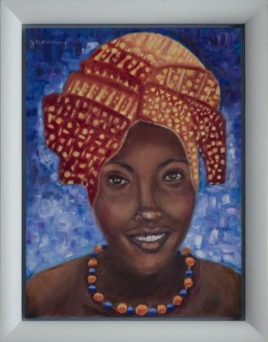 Portrait of a smiling woman with a patterned headwrap and beaded necklace.