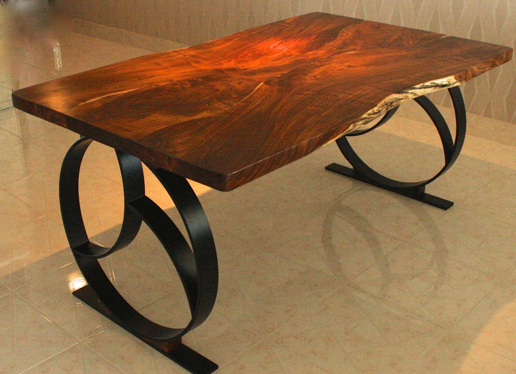 Custom dining room table hand crafted from Florida Keys Wild Tamarind. The Base is cold forged steel