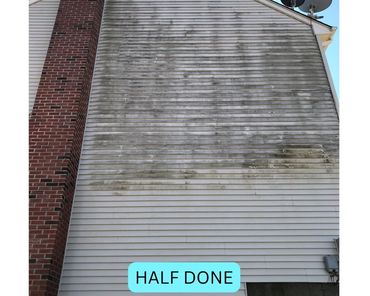 White vinyl siding showing half of it before and the other half after soft washing.