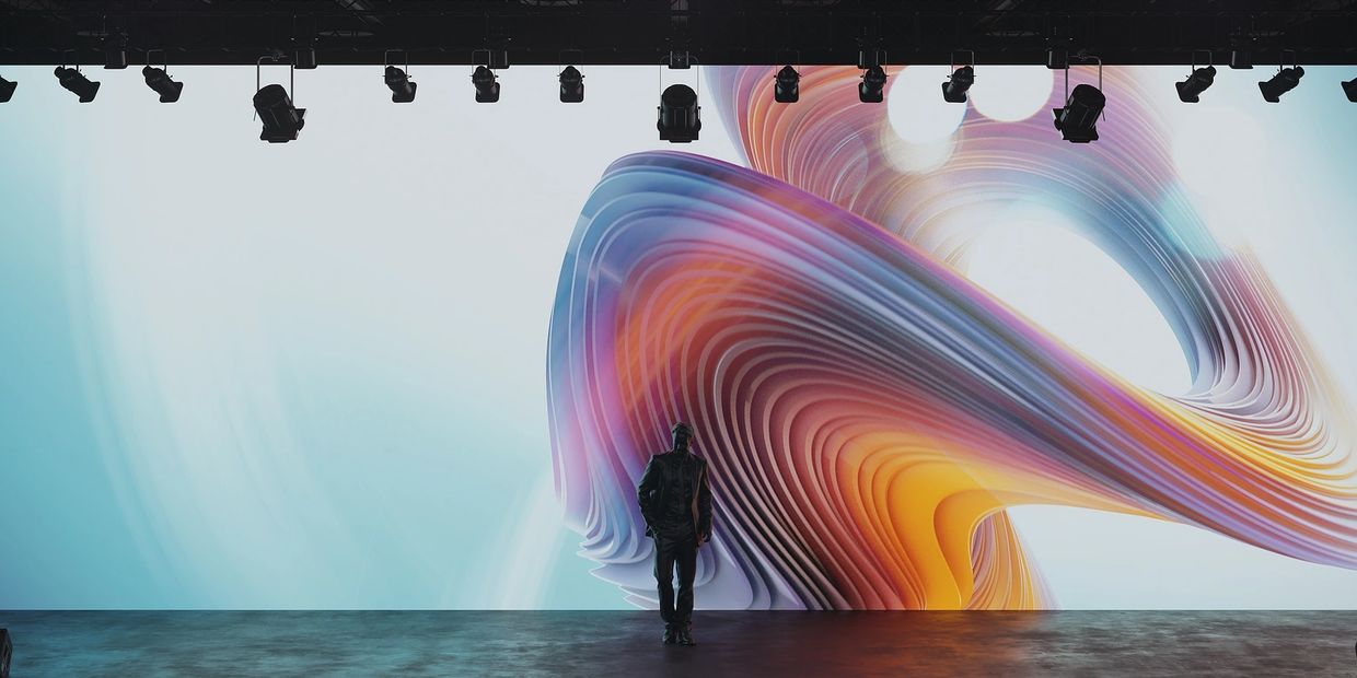 Conference stage with a man that appears to be walking out of the screen. Bring your vision to life!