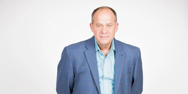 Man in a blue blazer with a light blue shirt.