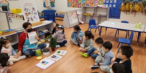 Teacher reading to young children in a classroom.