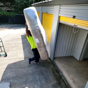Mover lifting king mattress at life storage in Douglasville, GA.