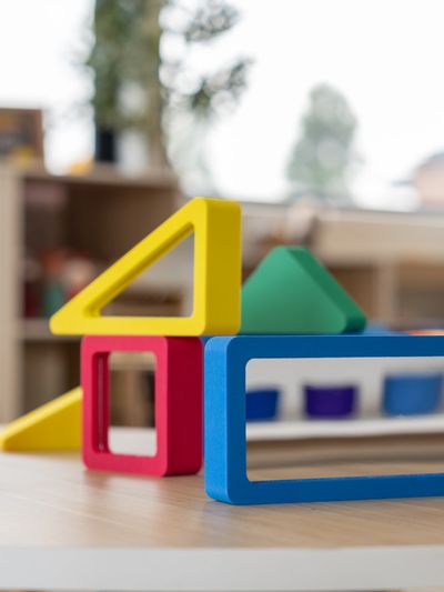 Colorful wooden geometric shapes arranged on a table.