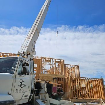 Saleen Crane loading trusses to residential building, new construction, skilled operator Twin Falls