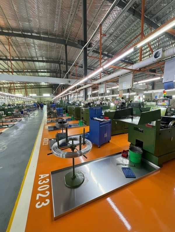 Interior of an industrial manufacturing facility with machines and workspace.