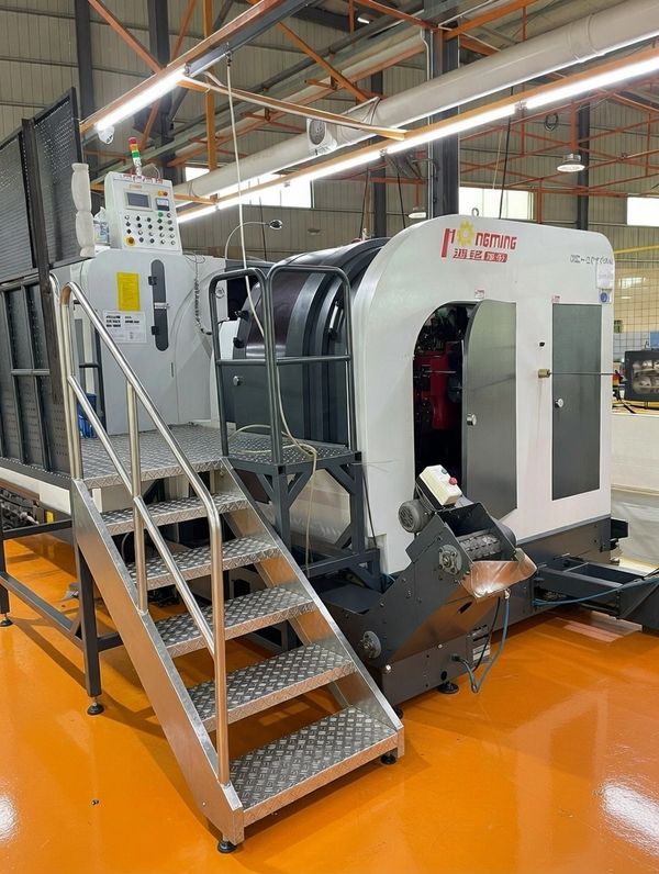 Industrial machine with metal stairs in a clean factory setting.