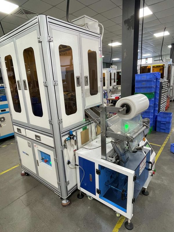 Industrial packaging machine with control panel in a factory setting.