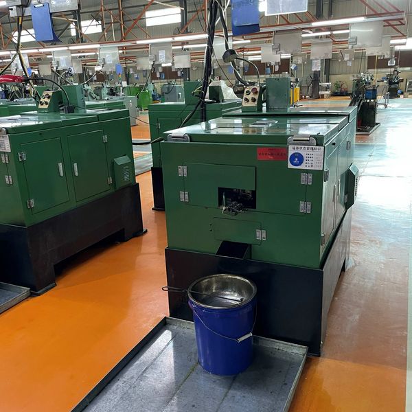 Green industrial machines in a factory setting.