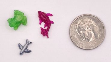 Hand-cast resin green frog, pink koi fish, and silver airplane