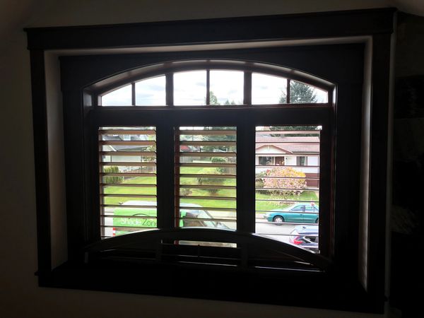 Wood Shutters on arched window by ShadeZone blinds in Gibson bc.
