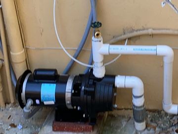 Digital Rainbird timer, 1.5 horsepower pump, and electric valve installation.