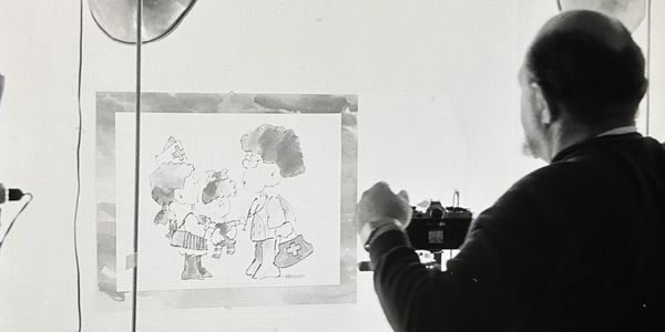 Photo of Saul Mandel photographing his own original art in his studio, taken by his daughter Suzy