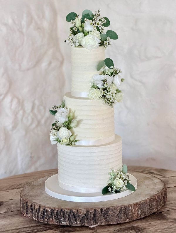 3 Tier Rustic Textured Buttercream wedding Cake with fresh white roses and artificial foliage