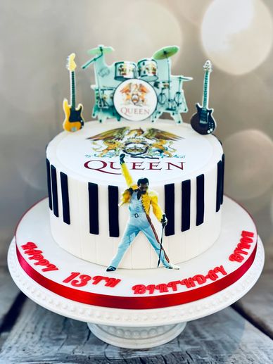 Queen themed fondant cake with edible printed Freddie Mercury on the front and Queen logo on top