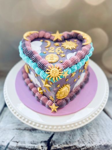 Purple, blue and lilac vintage heart cake with gold sun, moon and stars decorations