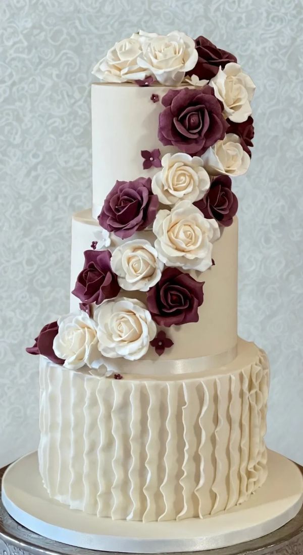 3 tier ivory and burgundy wedding cake with cascading sugar roses