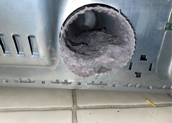 Clogged dryer exit that connects to dryer vent pipe, allowing little to no air flow out