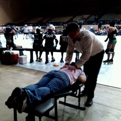 Dr. Cox  adjusting on the sidelines at the Assassination City Roller Derby bout in Fair Park