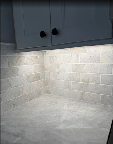 Concealed LED lighting was installed beneath the cabinetry to provide bright, even illumination.