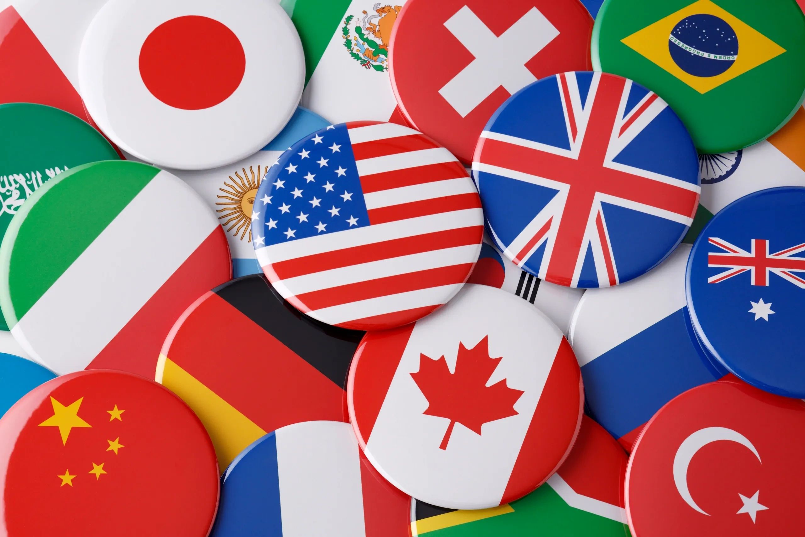 A collection of round pins featuring various international flags.
