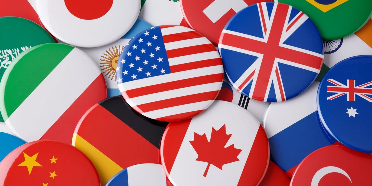 A collection of round pins featuring various international flags.