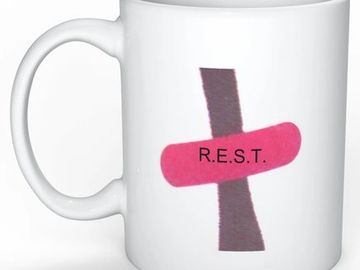 White coffee mug with pink and black cross of the REST logo