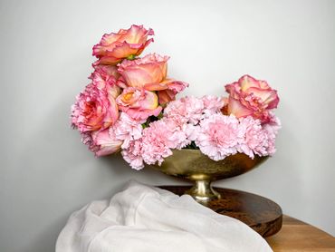 pink carnations and roses in gold vase