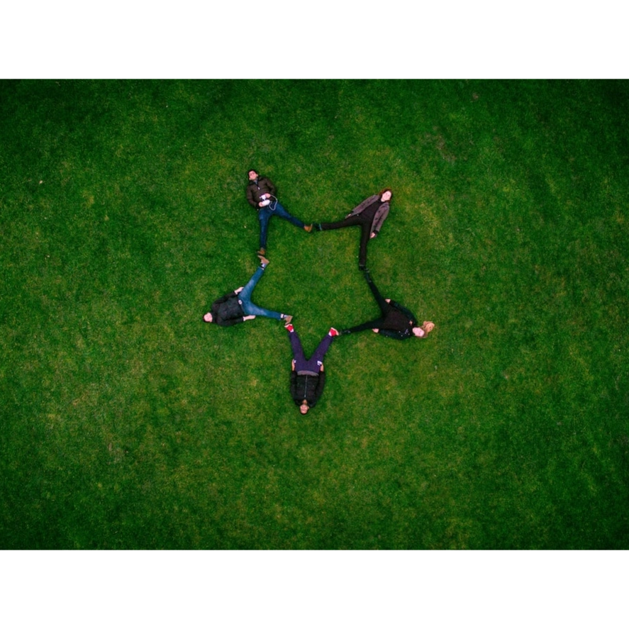gathering of people coming together to form a star, the beginning of the journey of something great