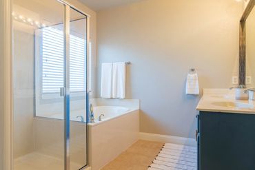Primary bathroom with stand up shower and soaking tub located in Fort Worth Texas