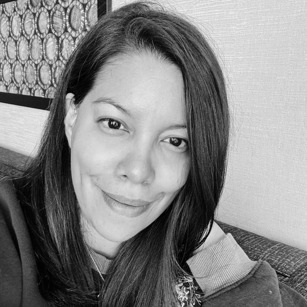 Black and white portrait of a woman smiling gently.
