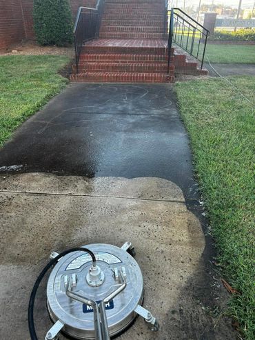 Difference in walkway before and during pressure washing